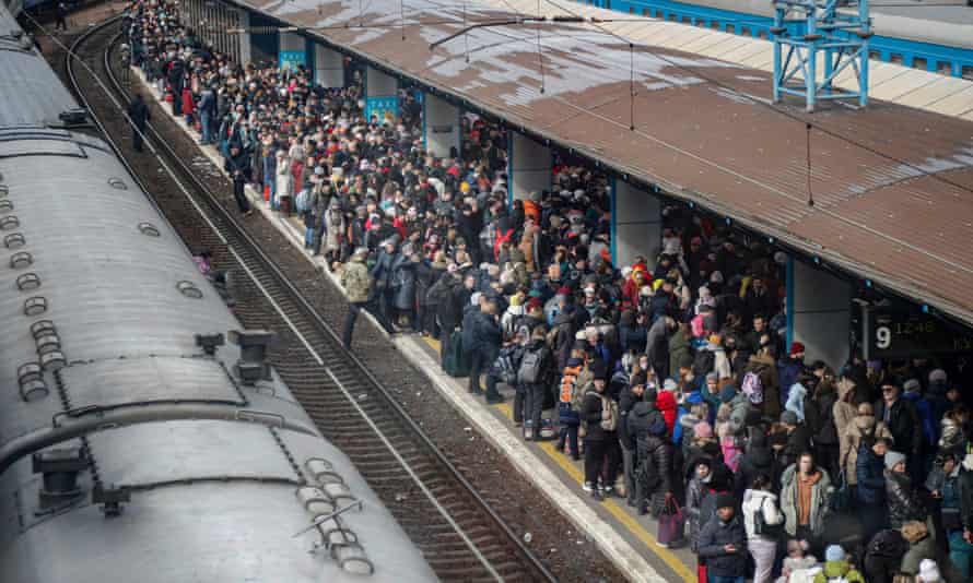 People gather at the main train station as they try to flee Kyiv, Ukraine.