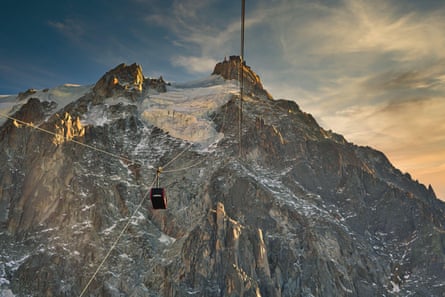 A rugged mountain with solitary gondola on wires