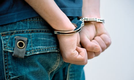 A teenager in handcuffs