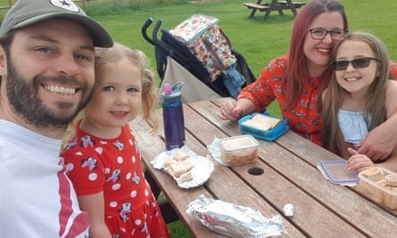 Gemma, her partner and her two girls having a picnic