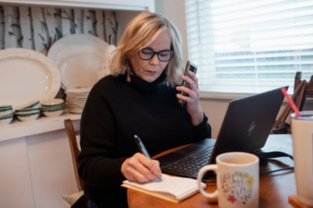 Doni Chamberlain at her desk taking notes