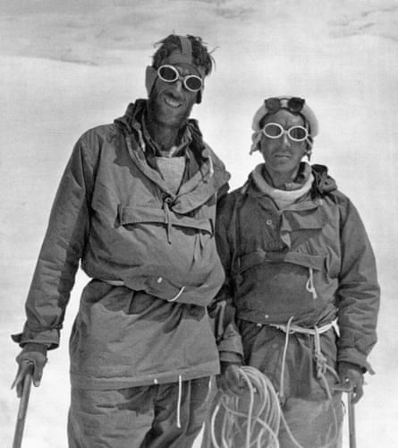 A black and white photo of two men in climbing gear and goggles