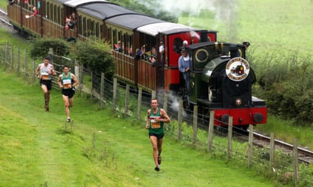 A steam train and fell runners compete in Race the Train near Tywyn, Wales.