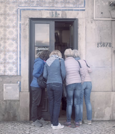 Tourists look into a shop in Lisbon’s Graça neighbourhood.
