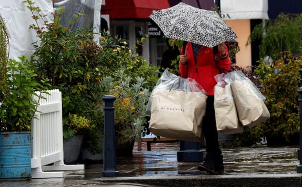 A shopper carries bags in Bicester Village, Oxfordshire.