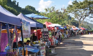 Food and souvenir stalls along the road to the Tham Luang cave complex, Thailand.