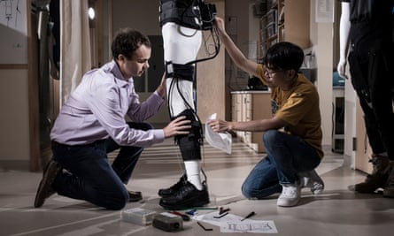 Conor Walsh and a colleague assemble an exosuit on a mannequin.