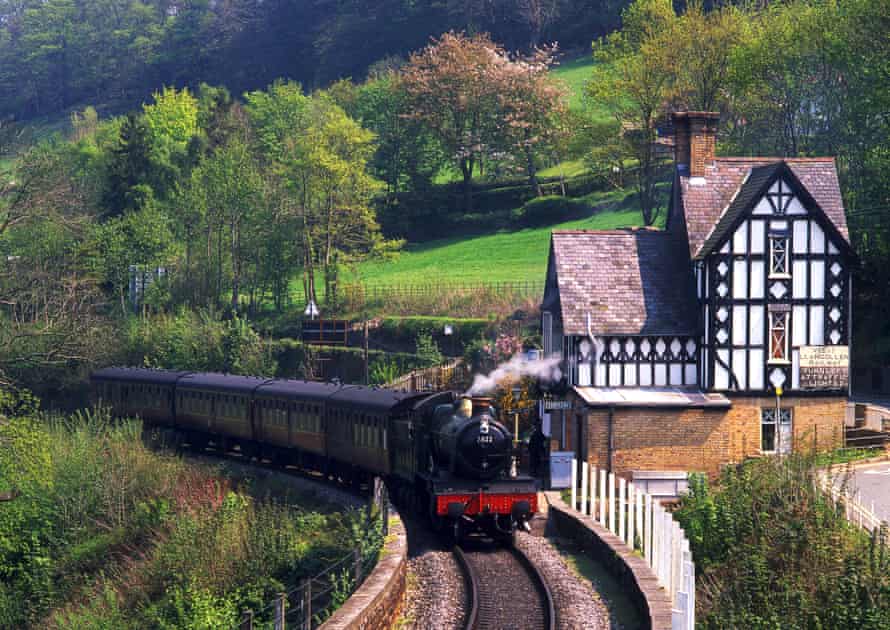 A steam locomotive passes the Tudor-style stationmaster’s house at Berwyn.