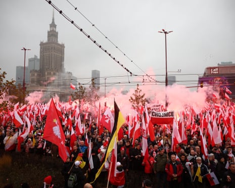 Smoke rises as people use flares during a march to mark the 107th anniversary of Polish independence, near the Palace of Culture and Science in Warsaw, Poland.