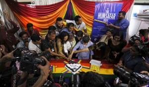 Activists cut a cake as they celebrate in Mumbai
