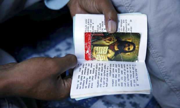 A Christian migrant from Eritrea prays and reads the bible