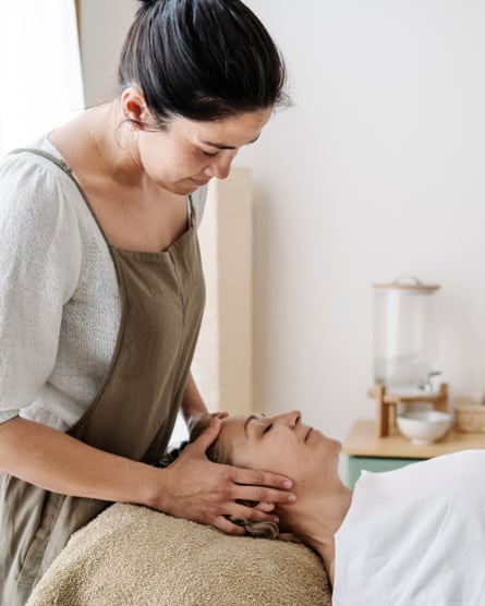 Adult woman receiving head massage at beauty spa