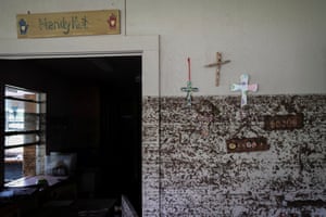 Crosses hang from a wall with flood marks