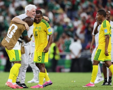South Africa head coach Hugo Broos (second from left) gets hugged by his players after the 1-0 win against South Korea