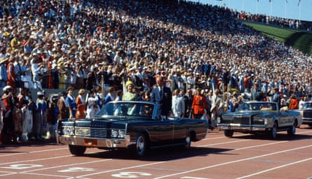 pair in car on track in front of crowd