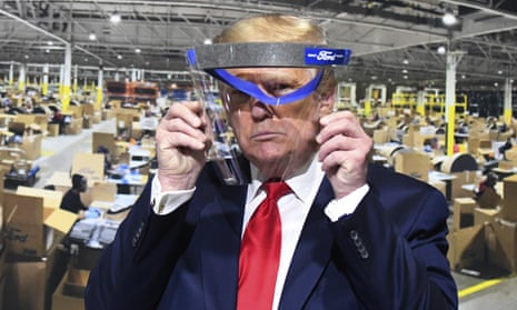 Donald Trump looks through a face shield at Ford’s Rawsonville Components Plant in Ypsilanti, Michigan.