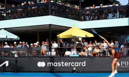Spectators at the Australian Open’s new bar overlooking court six watch local hope Taylah Preston serve in her first round doubles match.