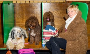 Woman wearing a coat that resembles her dogs' brown coats, at Crufts dog show 2019