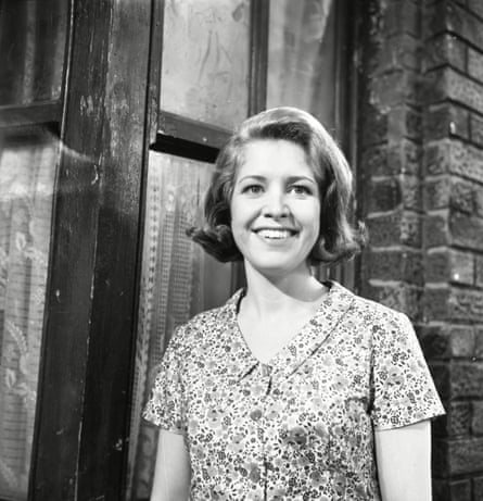 black and white photo of anne reid smiling in a flowery shirt