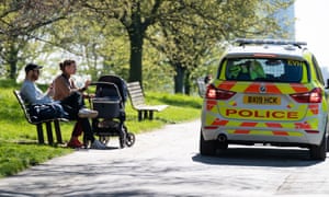 Police interrogate a couple with a pushchair on Primrose Hill, London