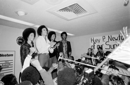 four people smiling in front of crowd