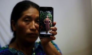 Dominga Vicente, a relative of Claudia Patricia Gómez Gonzáles, shows a photo of her during a press conference in Guatemala City on 25 May.
