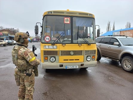 Refugees evacuate Volnovakha in a school bus