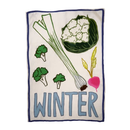 White tea towel with the word winter in blue and big pictures of vegetables