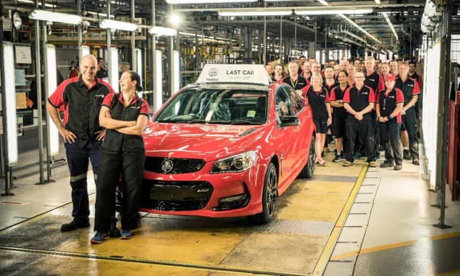 Staff posing for a photograph with the last vehicle to roll off the production line at the Holden plant in Elizabeth, Adelaide on 20 October 2017