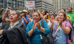 Protesters rally outside the JPMorgan Chase headquarters in New York, urging them to stop financing Geo Group and CoreCivic, on 26 September 2018.