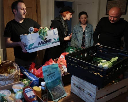 Four people with lots of boxes of food