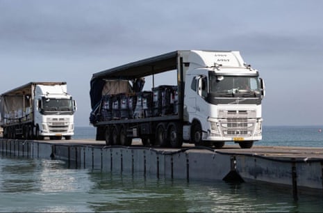 The US reported that aid trucks hadstarted leaving the temporary port in Gaza on Friday.