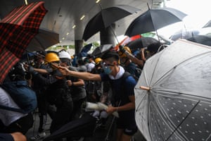 Protesters clash with police during a demonstration outside the legislative council building