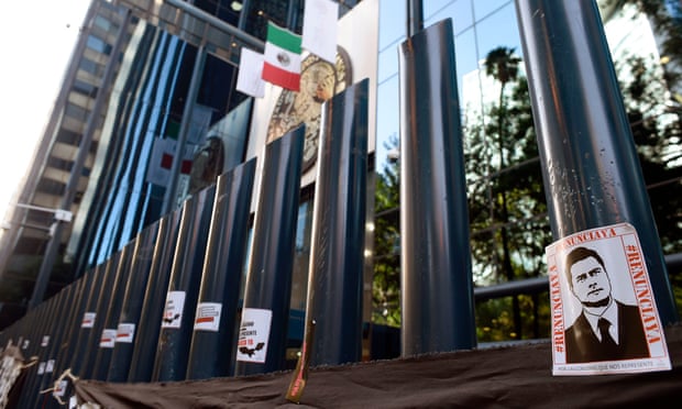 Stickers with the image of the Mexican president, Enrique Peña Nieto, are stuck on columns outside the building of the attorney general’s office during a protest against alleged government spying.