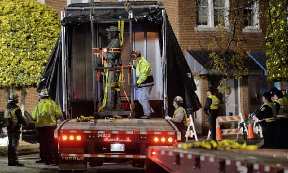 Workers load a Confederate statue on to a truck after it was removed from its spot in front of the historic Chatham county courthouse in Pittsboro, North Carolina, early on Wednesday.