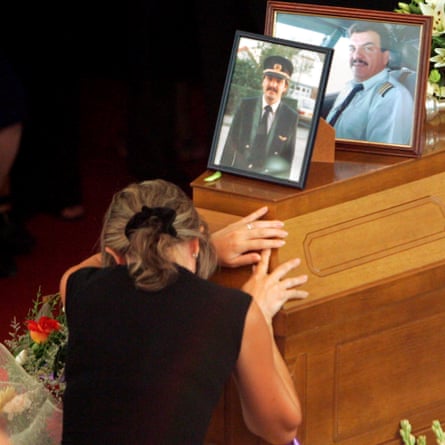 The first officer’s wife at his funeral three days after the crash.