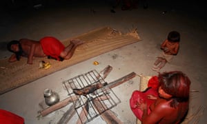 An Araweté family grilling fish in Juruanty village one evening.