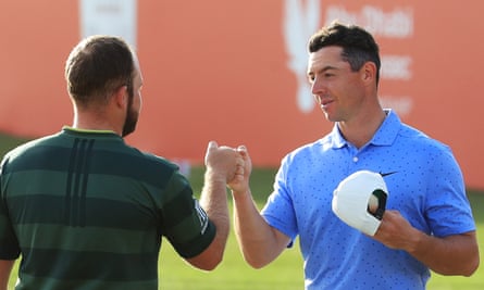 Tyrrell Hatton and Rory McIlroy bump fists on the 18th green after the Englishman’s win at the Abu Dhabi Championship.