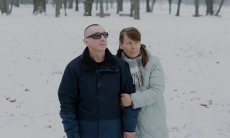 Serhiy Sydorenko, a Ukrainian paralympic athlete whose eyesight was restored in Poland where he sought refuge following the Russian invasion of Ukraine, poses for a portrait with his wife Tamara in a park in Poznan, Poland