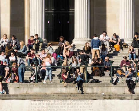Students sitting on the steps of the Portico and Quad at University College London (UCL), Bloomsbury, London.
