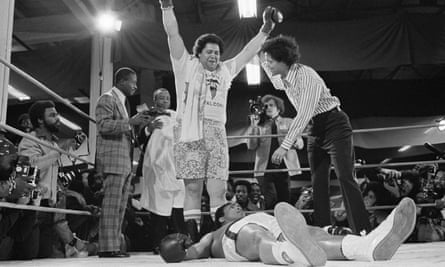 Muhammad Ali lies on the canvas after his second knockdown in first round of fight on Tuesday, Jan. 21, 1975 with Atlanta Mayor Maynard Jackson.
