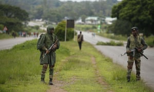 Soldiers patrol a highway in Harare