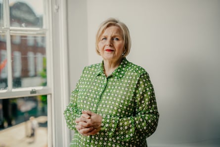 Donna Ockenden looks concerned as she poses next to a window wearing a green and white dress.