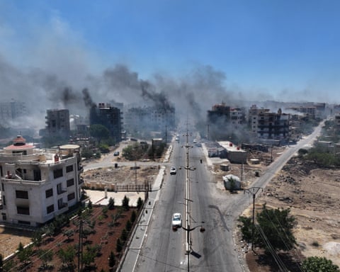 Aerial view of smoke rising in the city of Sweida.