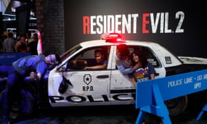 Attendees pose for a souvenir photo at Capcom’s Resident Evil 2 booth