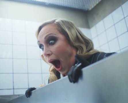 Gwendoline Christie peeking over the top of a toilet door