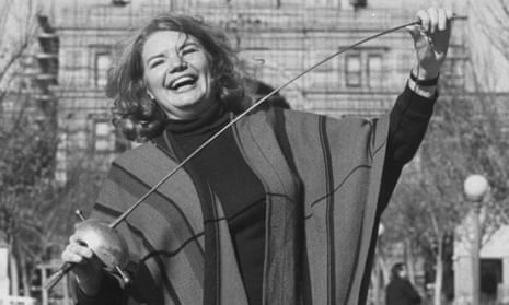 Molly Ivins, known for her rapier wit, poses with a fencing sword in front of the Texas state capitol in Austin.