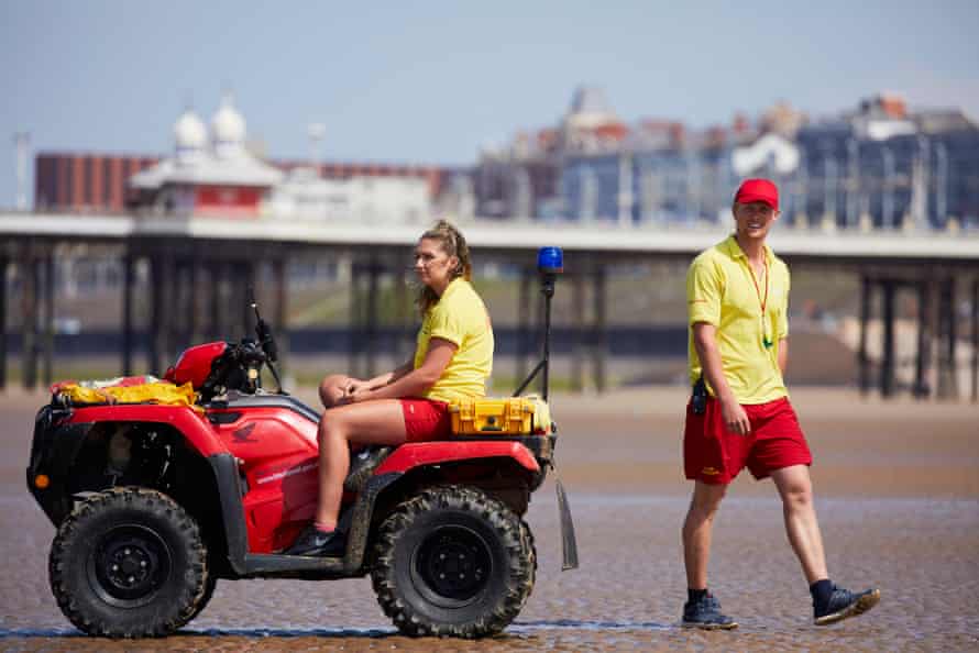 Lifeguards keep watch over the beach at the start of the school holiday season