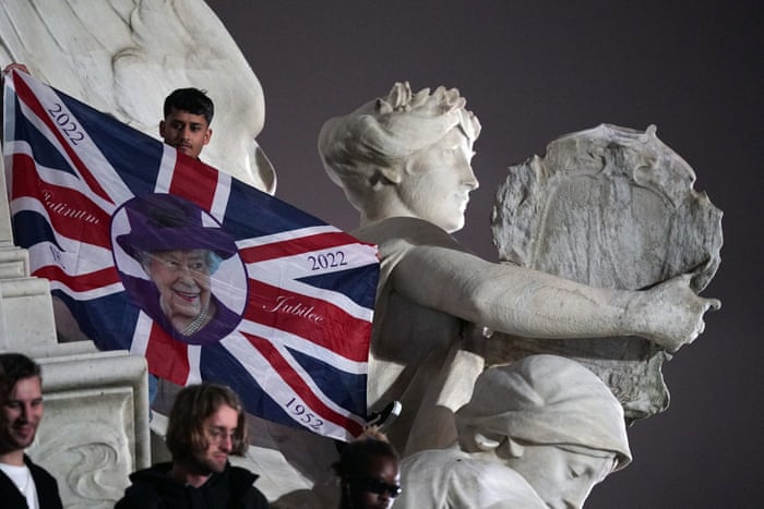 Mourners on Queen Victoria Memorial outside Buckingham Palace.