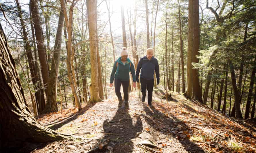 Camara Chambers and her partner Graham walking through woodland